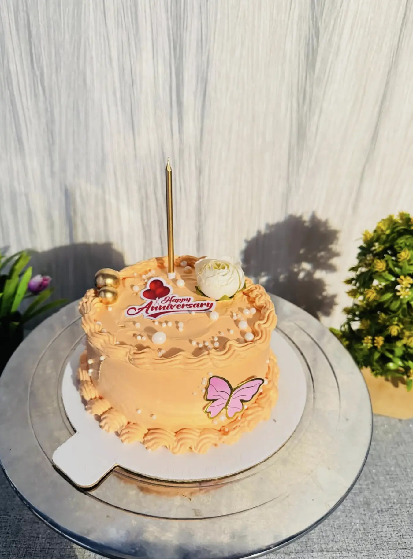 Peach anniversary cake with piped cream, pearls and a white rose by Kaur Bakehouse