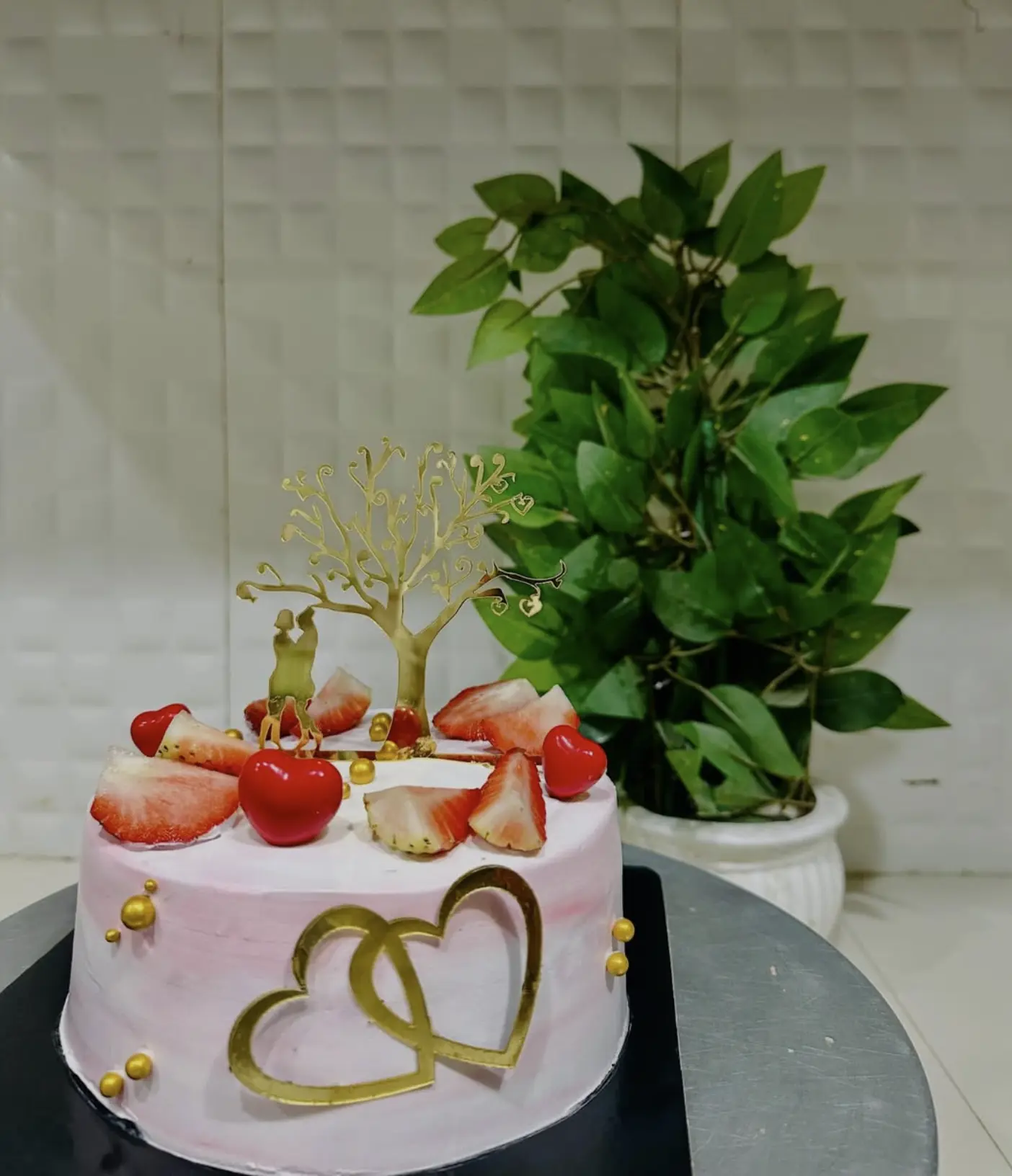 Pink strawberry celebration cake with gold hearts